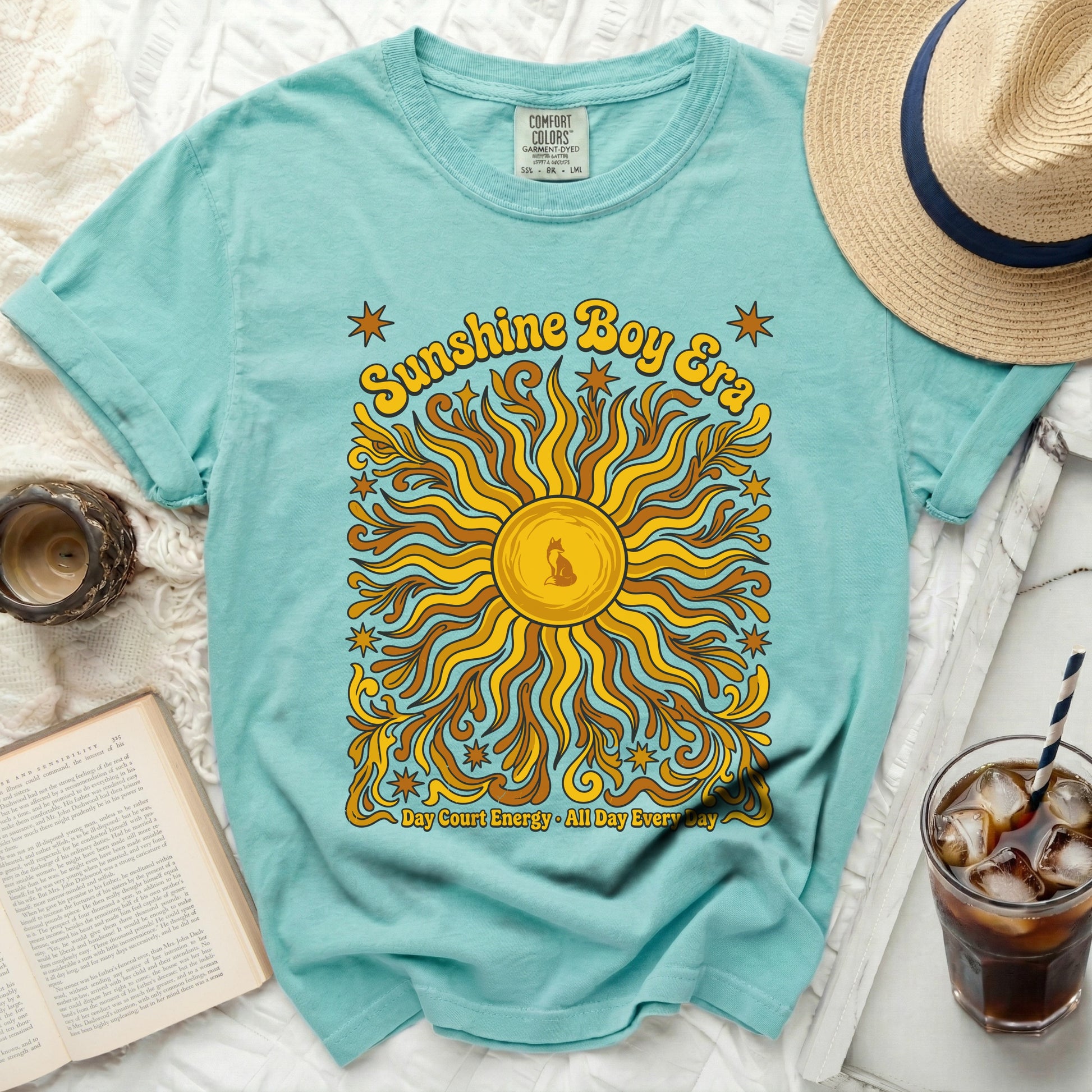 Teal t-shirt with "Sunshine Boy Era" and sun graphic.