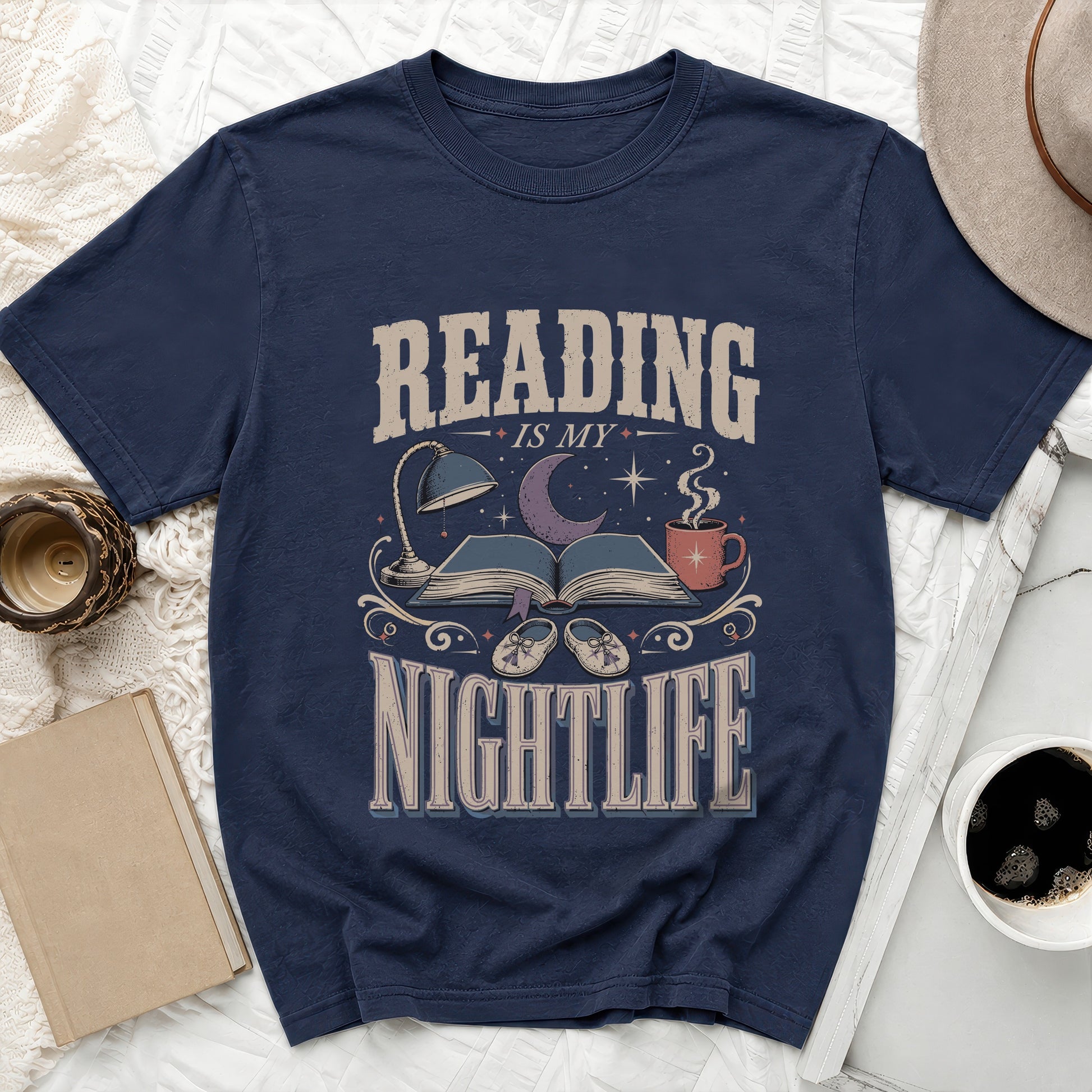 Navy t-shirt with "Reading Is My Nightlife" text, book, moon, and slippers graphic.