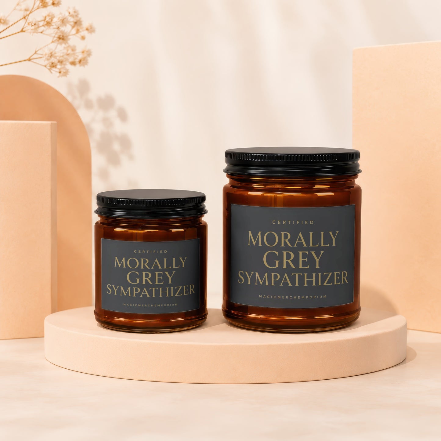 Two amber glass candles labeled "Morally Grey Sympathizer" on a beige pedestal.
