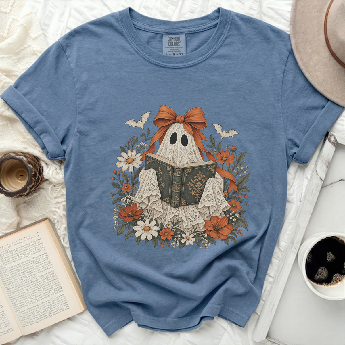 Ghost reading a book surrounded by flowers and bats, with a large orange bow.