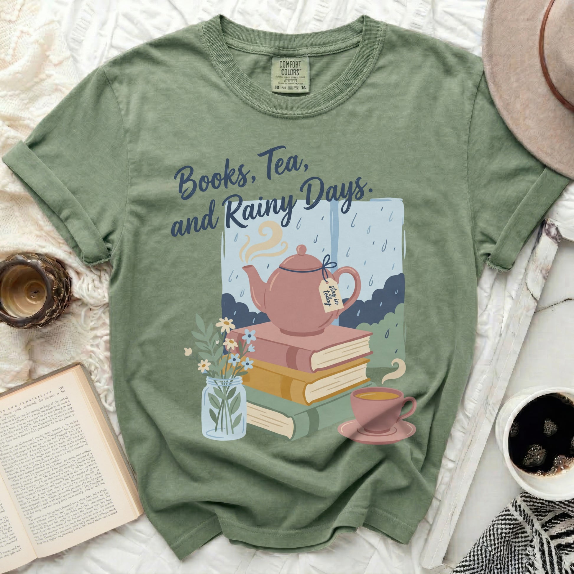 Green t-shirt with "Books, Tea, and Rainy Days" text and illustration.