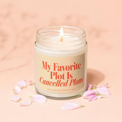 Glass jar candle with lit wick and text: My Favorite Plot Is Cancelled Plans