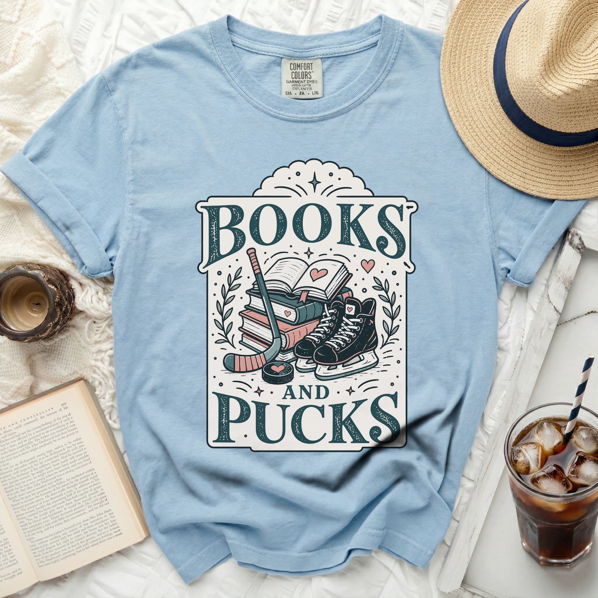 Light blue t-shirt with "Books and Pucks" graphic and hockey gear.
