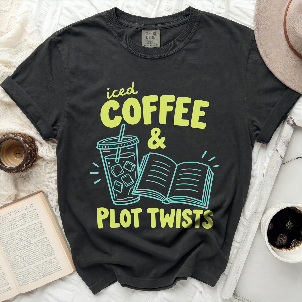 T-shirt with "iced COFFEE & PLOT TWISTS" text and graphics.