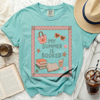 T-shirt with "My Summer is Booked" text and beach graphic elements.