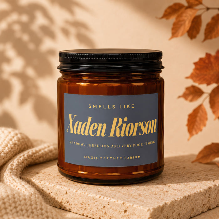 Amber candle jar with black lid, labeled "Xaden Riorson" and "Shadow, Rebellion and Very Poor Timing".