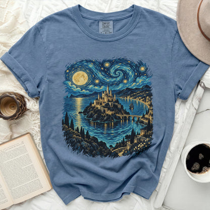 Blue t-shirt with a castle on an island under a swirling starry sky.