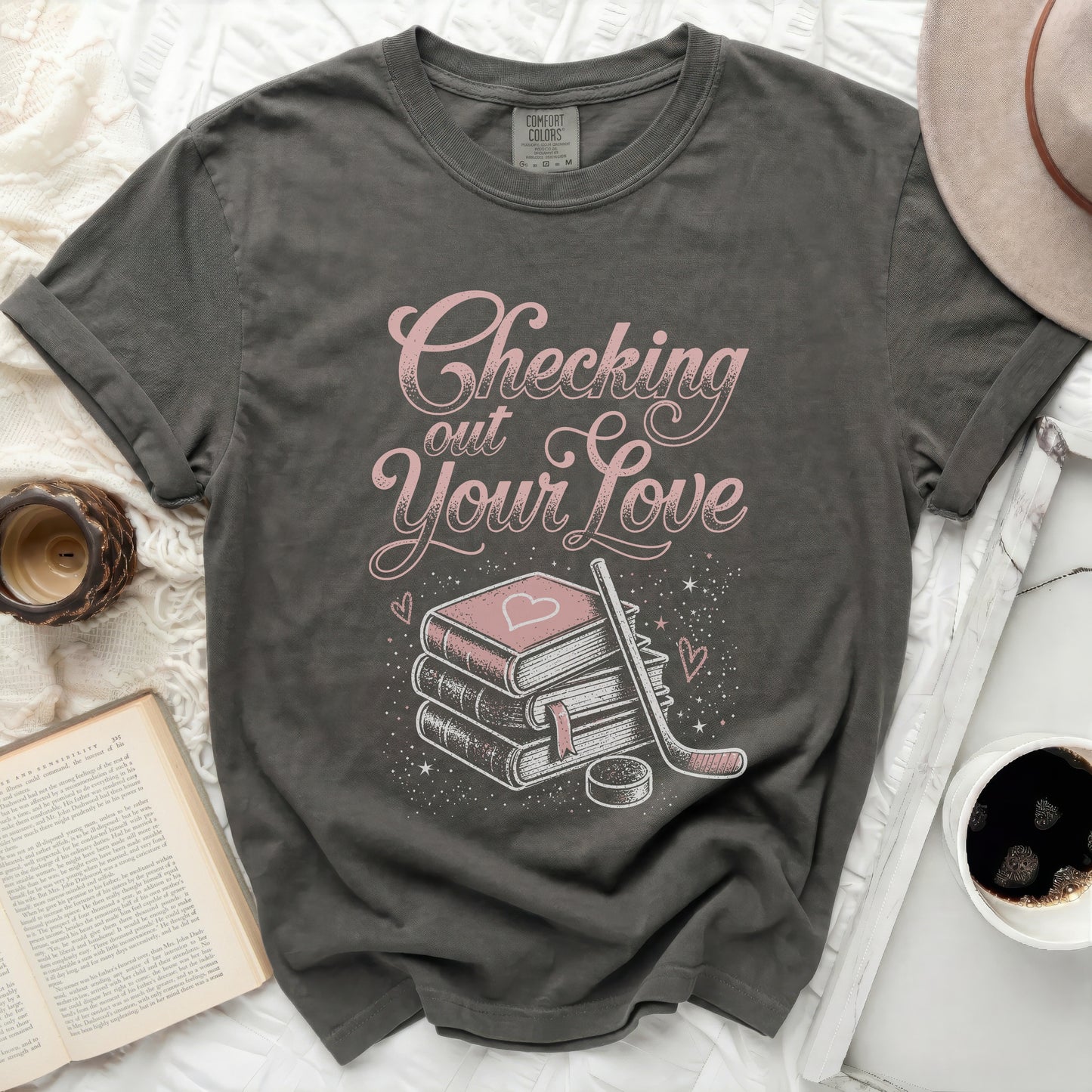 Dark gray t-shirt with "Checking out Your Love" text and book, hockey stick, and heart graphic.