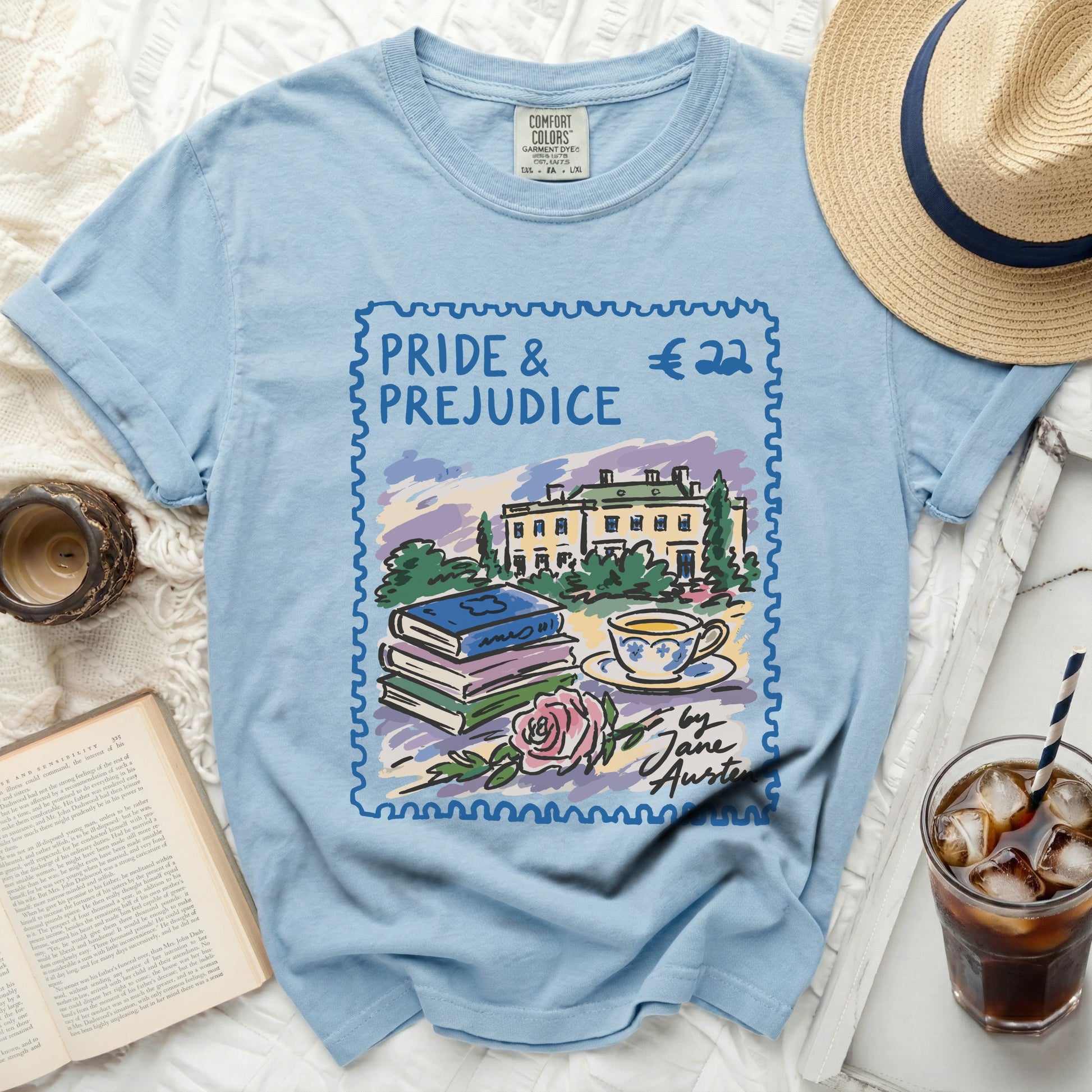 Light blue t-shirt with a stamp design featuring "Pride & Prejudice" and Jane Austen's name.