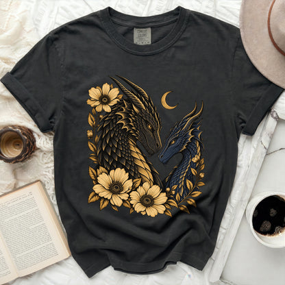 Dark t-shirt with gold and blue dragon illustration, flowers, and crescent moon.