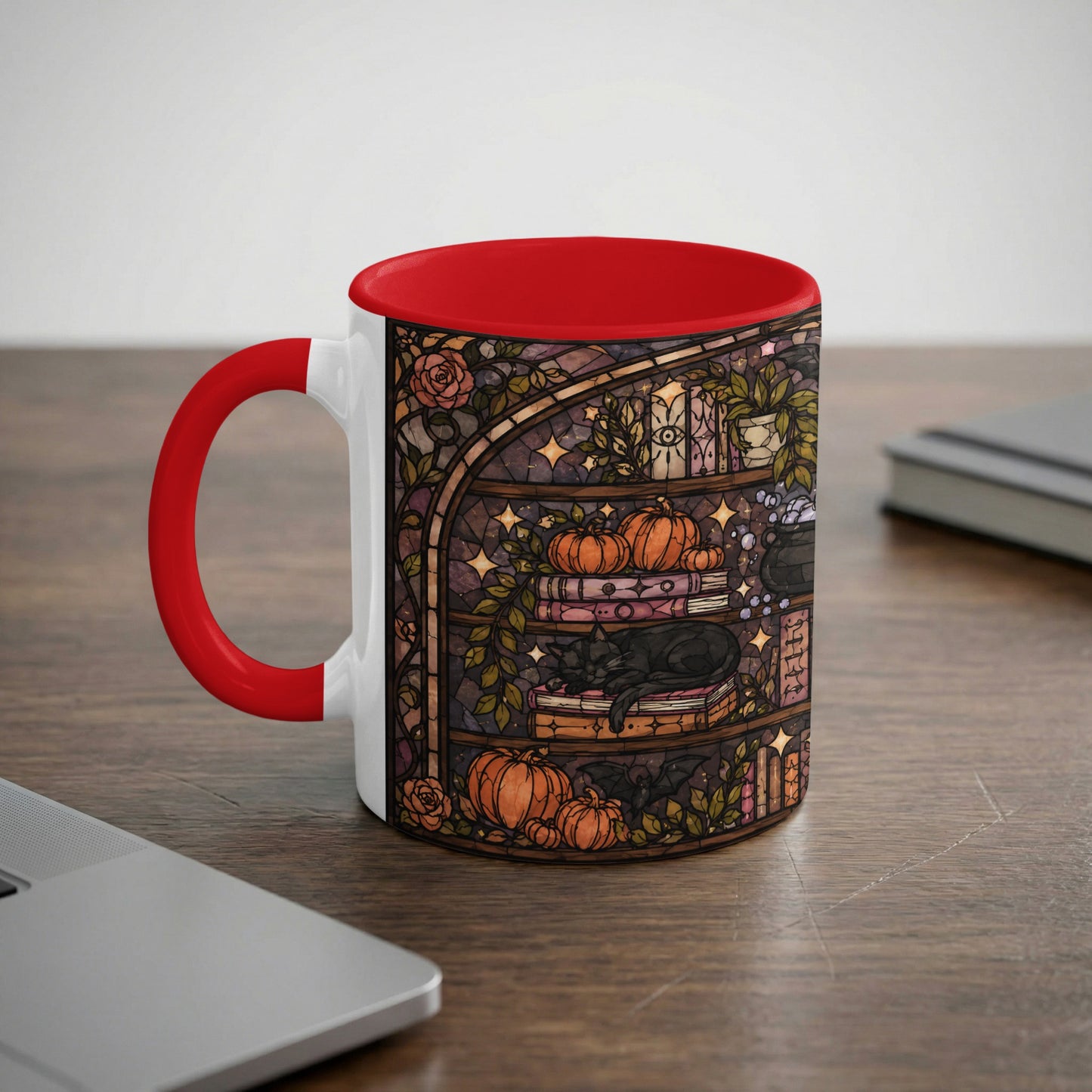 White mug with stained glass design of black cat, pumpkins, and books.