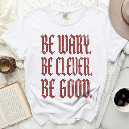 White t-shirt with red distressed text reading "BE WARY. BE CLEVER. BE GOOD."