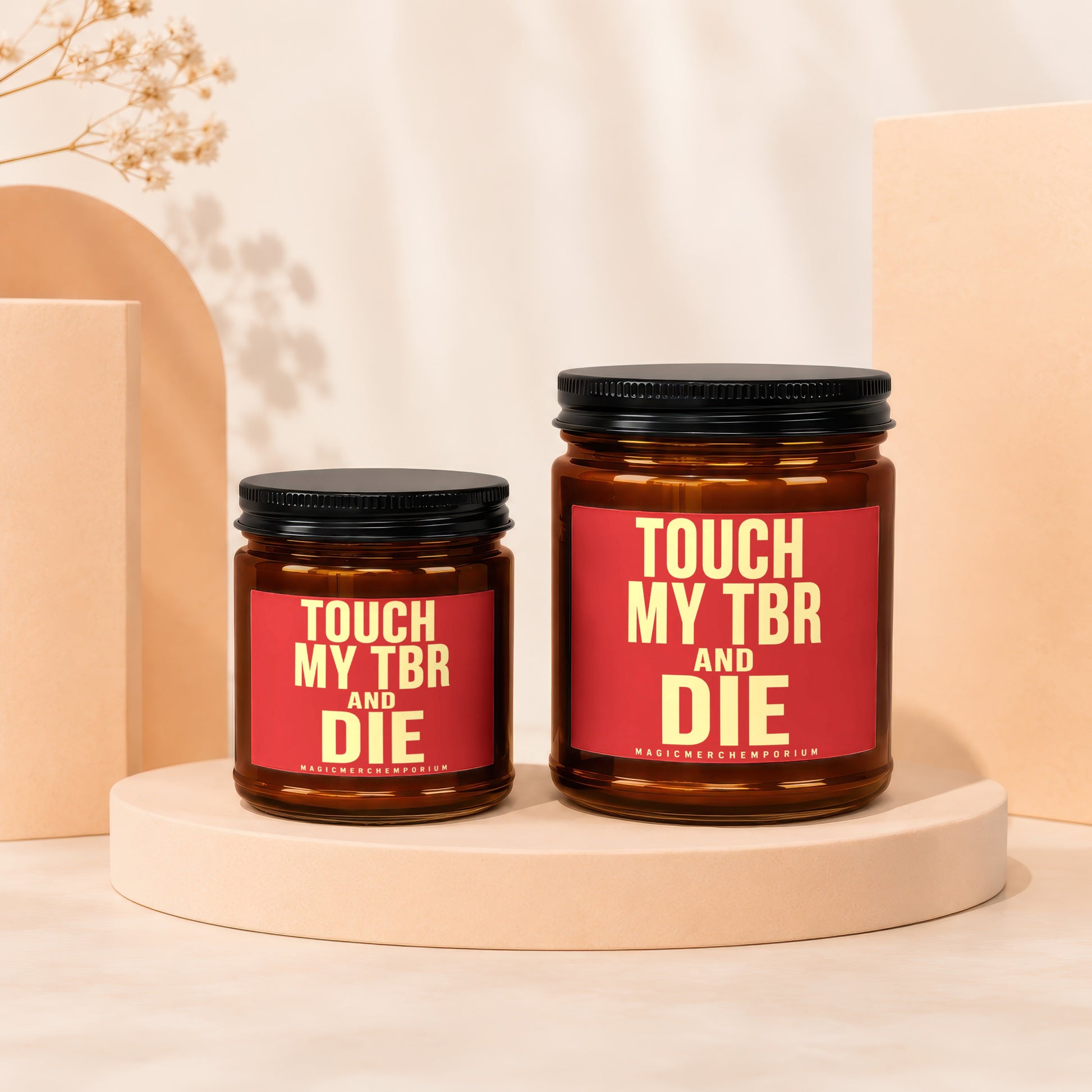 Two amber jars with black lids and red labels reading "TOUCH MY TBR AND DIE" and "MAGICMERCH."},