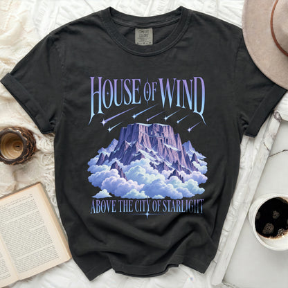 Dark t-shirt with "House of Wind Above the City of Starlight" text and mountain graphic.