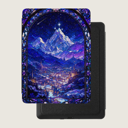 Stained glass art of a city and mountains under a starry night sky.