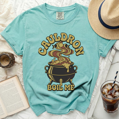 Aqua t-shirt with "Cauldron Boil Me" graphic featuring a bubbling cauldron.