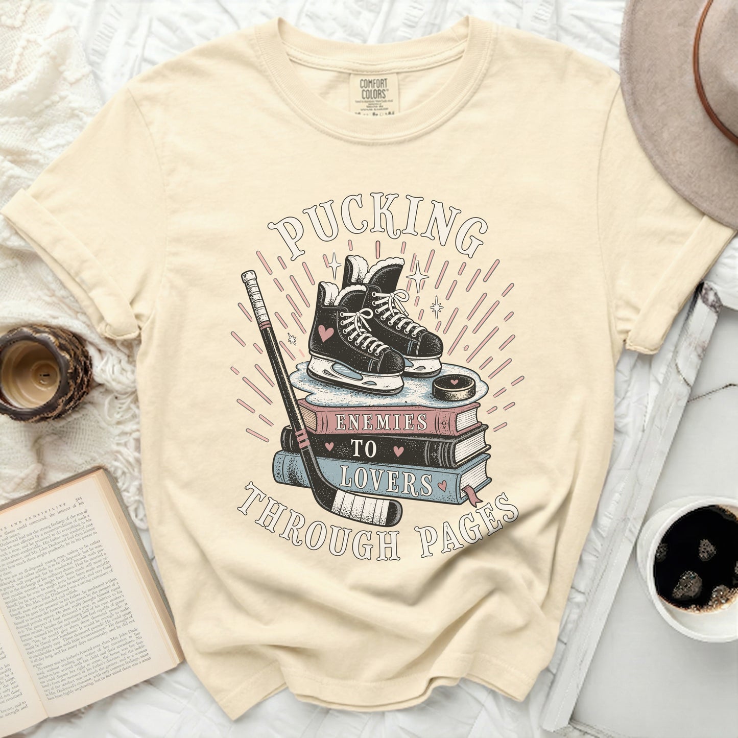T-shirt with hockey skates on books and text "Pucking to Lovers Through Pages".