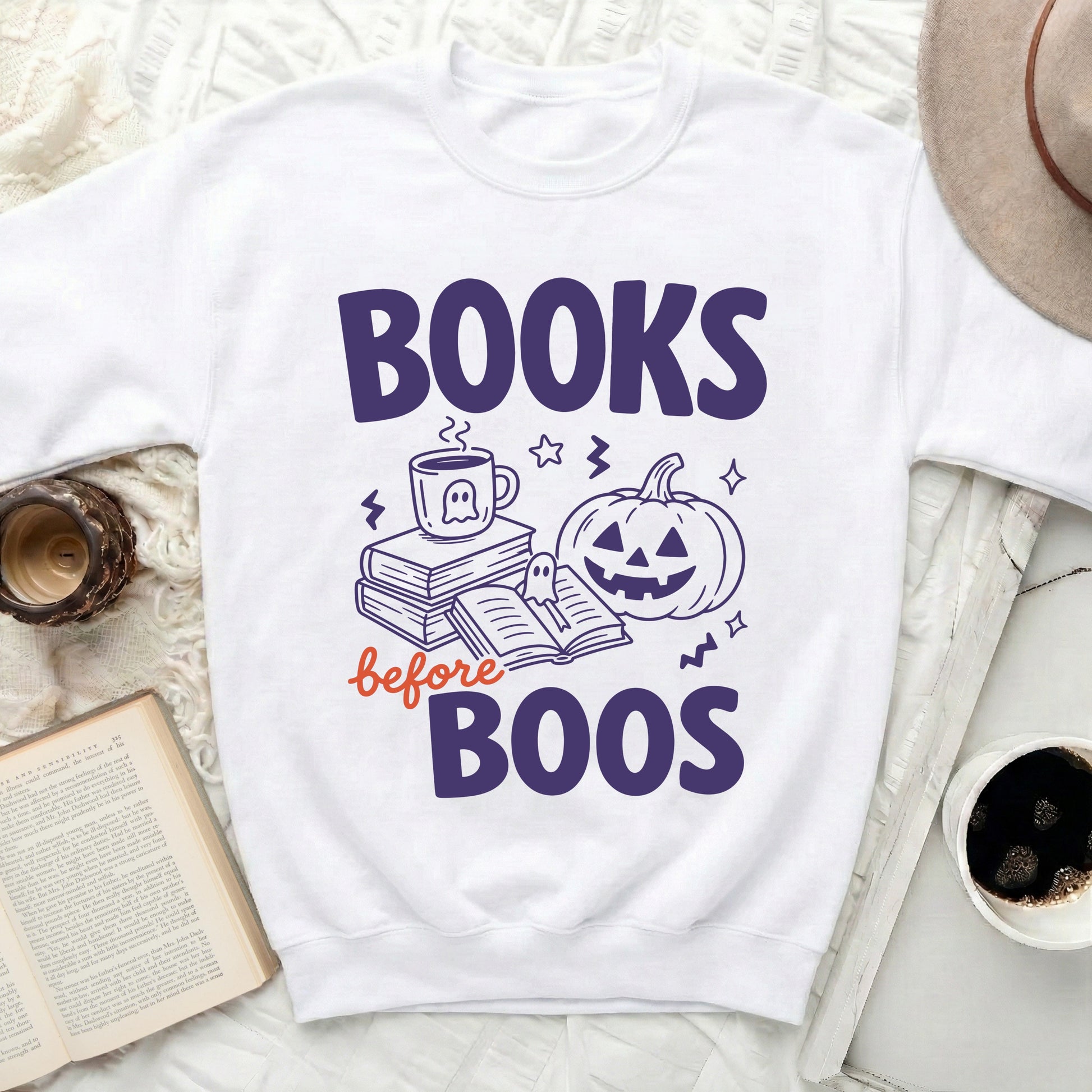 White sweatshirt with "Books before Boos" Halloween graphic.