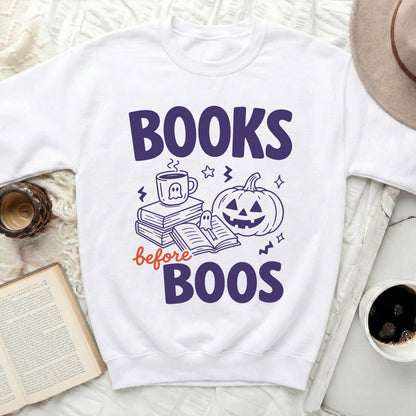 White sweatshirt with "Books before Boos" Halloween graphic.