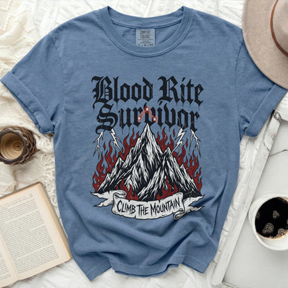 Blue shirt with "Blood Rite Survivor" and "Climb the Mountain" graphic.