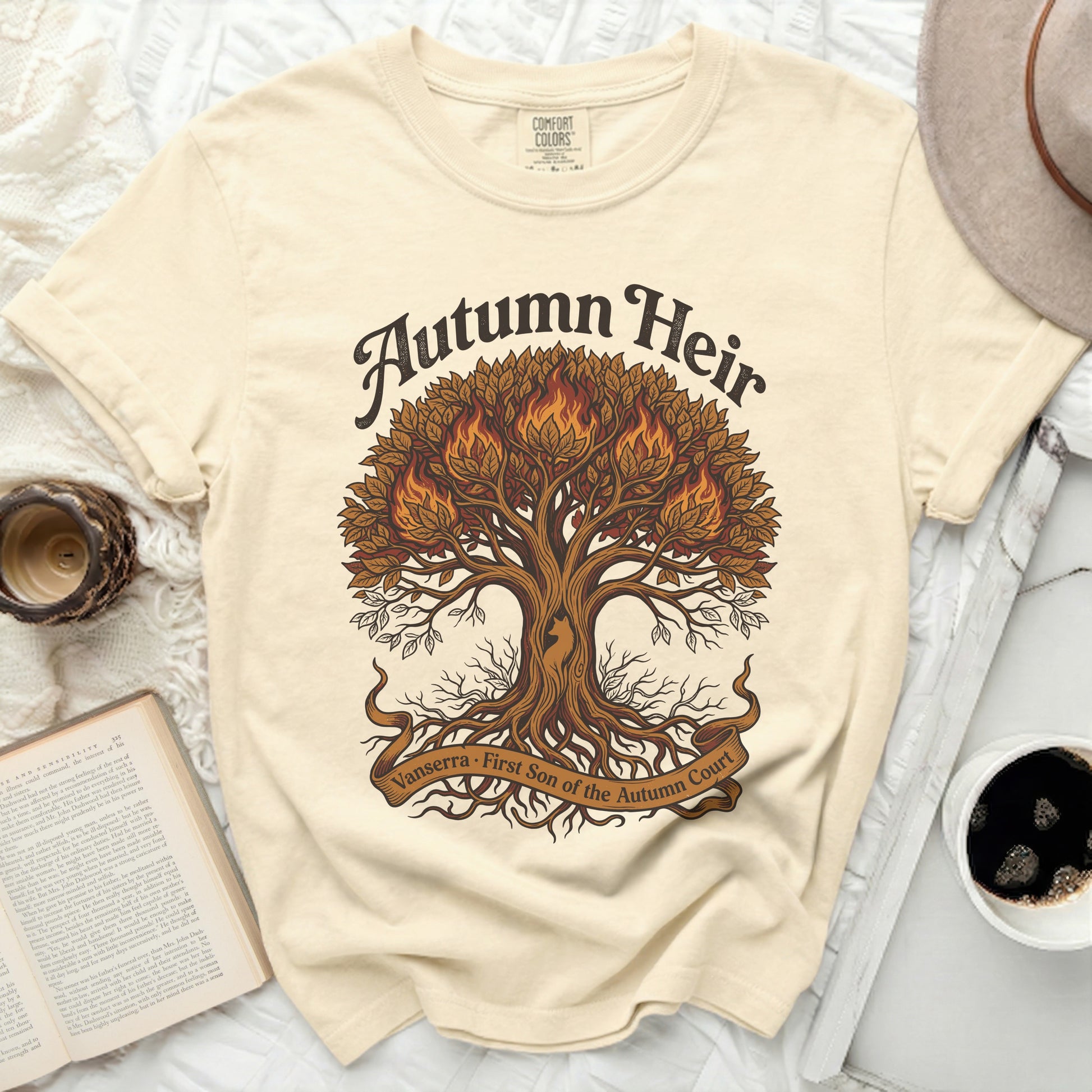 Cream t-shirt with an illustration of a flaming tree and text "Autumn Heir Vanserra First Son of the Autumn Court".