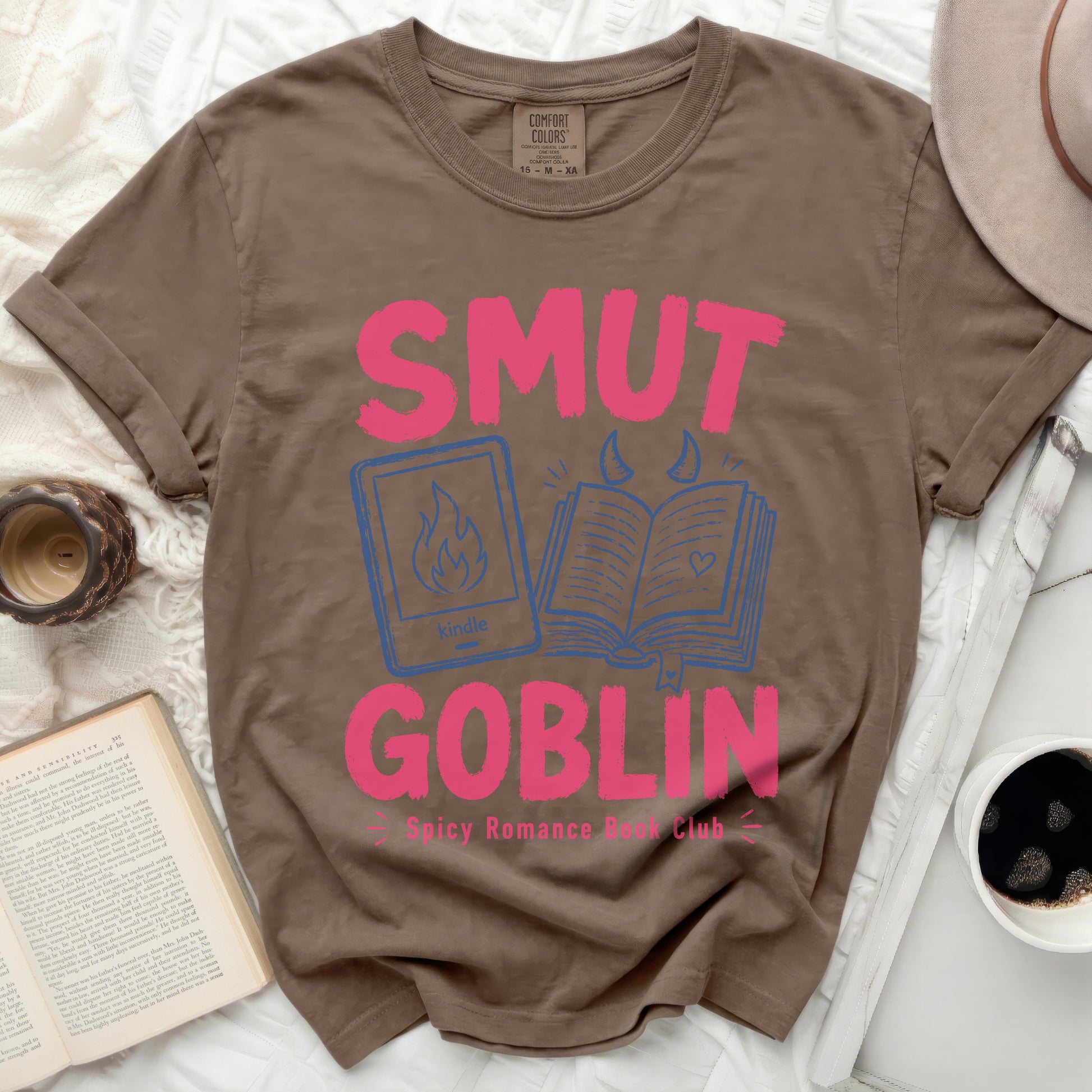 Brown t-shirt with "SMUT GOBLIN Spicy Romance Book Club" in pink.