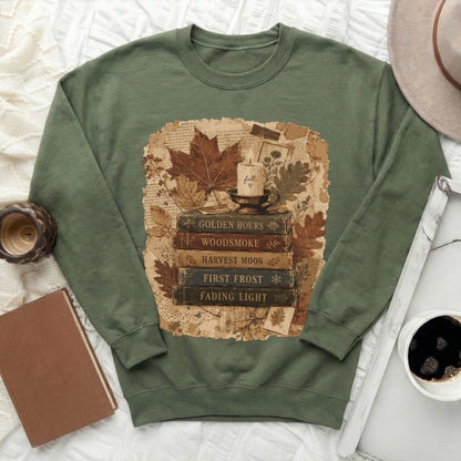 Green sweatshirt with vintage fall graphic featuring books, candle, and leaves.