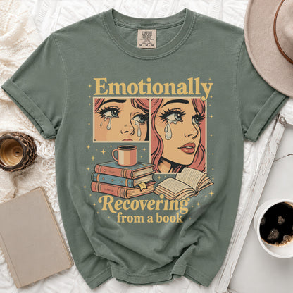 Green t-shirt with "Emotionally Recovering from a book" text and comic-style crying faces.