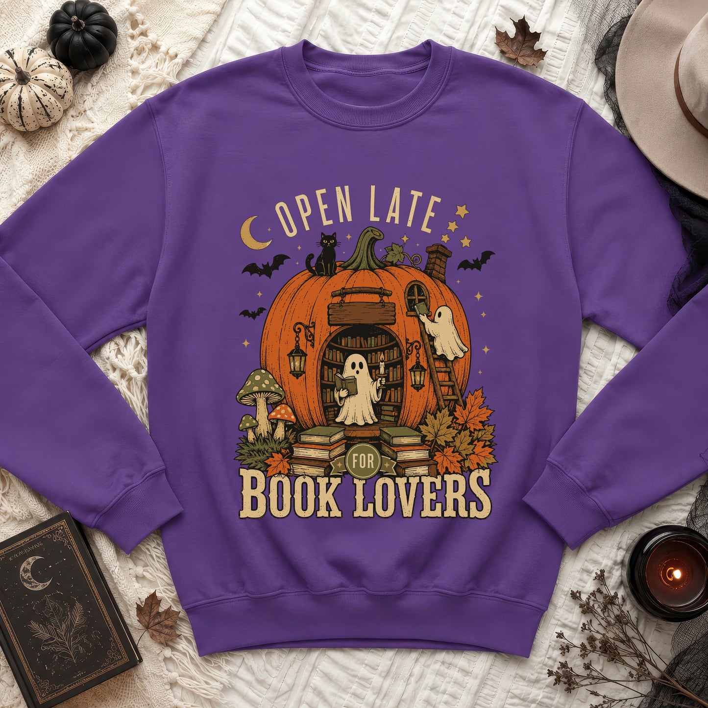 Purple sweatshirt with Halloween pumpkin graphic, "Open Late for Book Lovers" text.