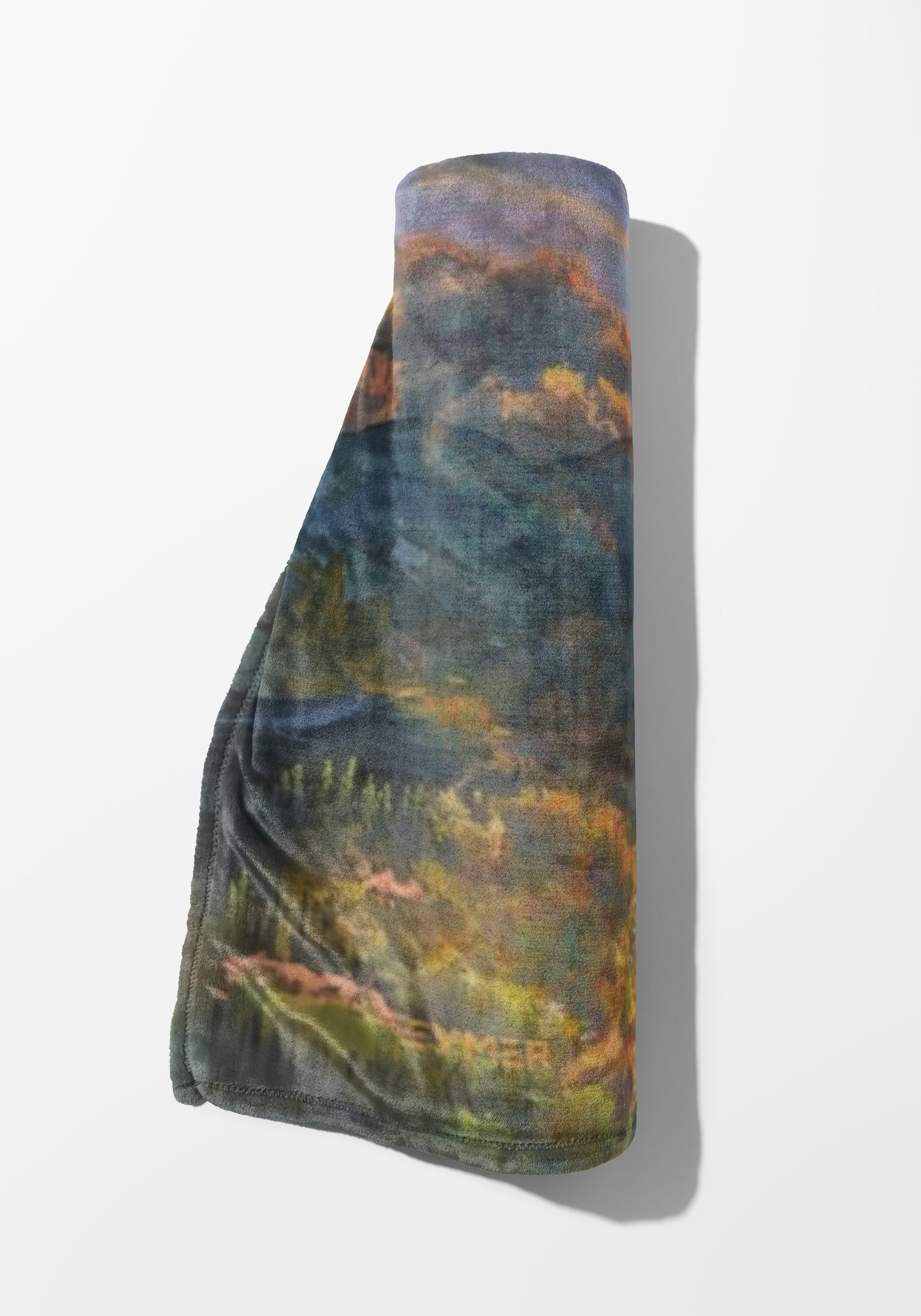 Rolled towel with impressionistic landscape print in blues, greens, and oranges.