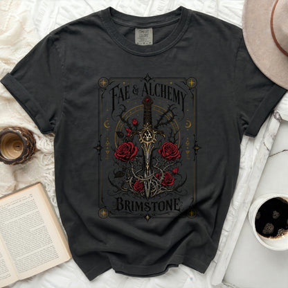 Dark t-shirt with "Fae & Alchemy Brimstone" in decorative gold design.