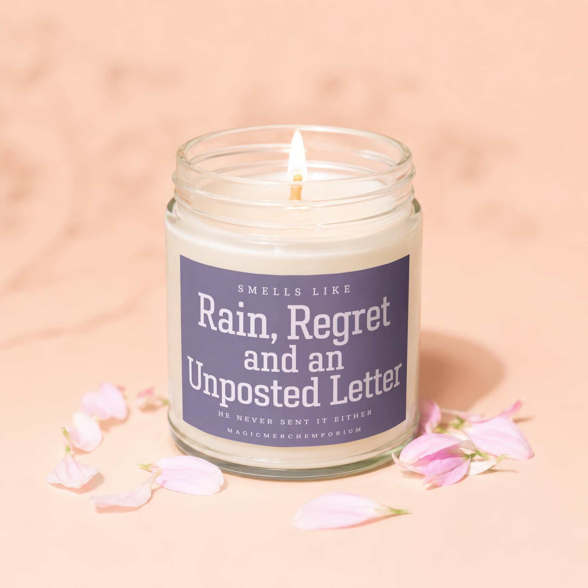 Candle with text "Rain, Regret and an Unposted Letter" on a purple label.
