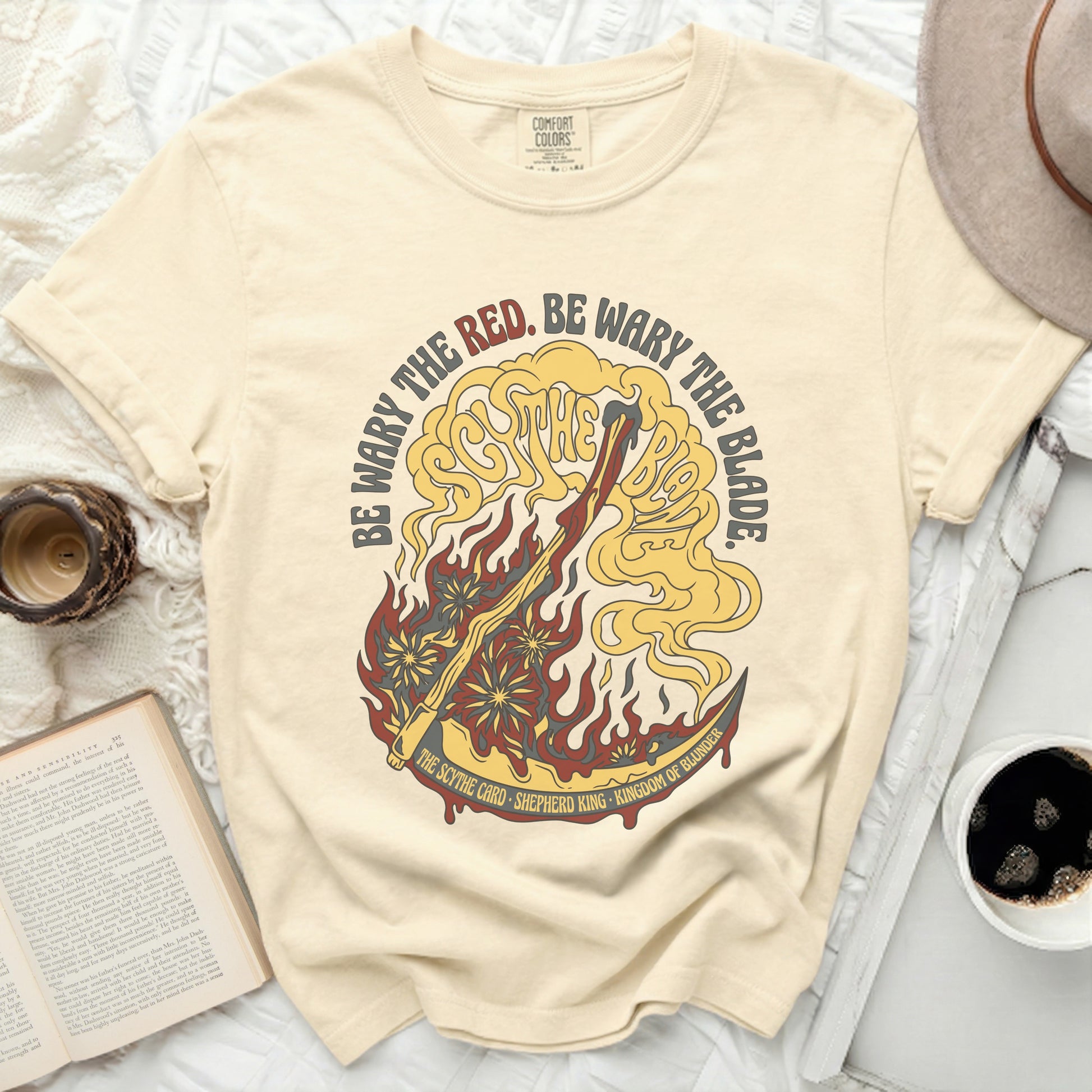 Cream t-shirt with "Be Wary the Red. Be Wary the Blade" text.