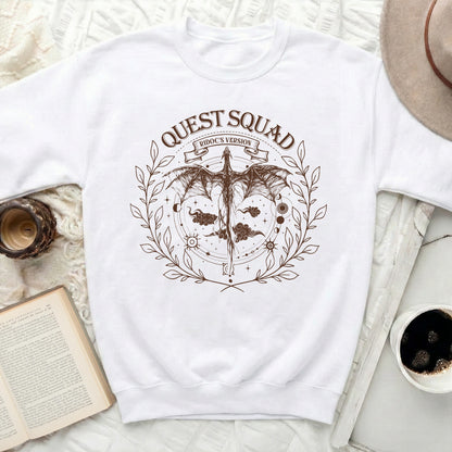 White sweatshirt with brown dragon and text graphic.