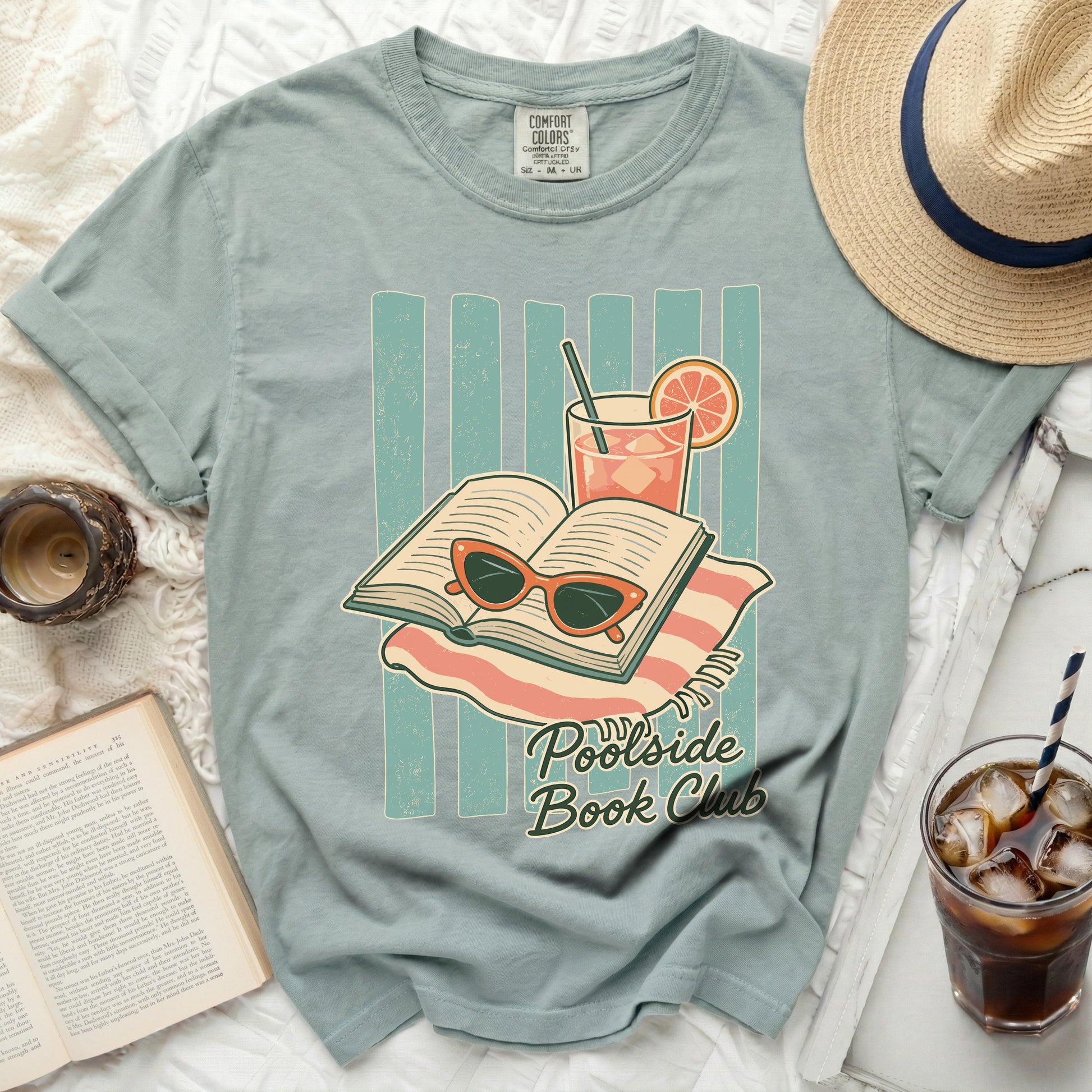 T-shirt graphic with open book, sunglasses, drink, and "Poolside Book Club" text.