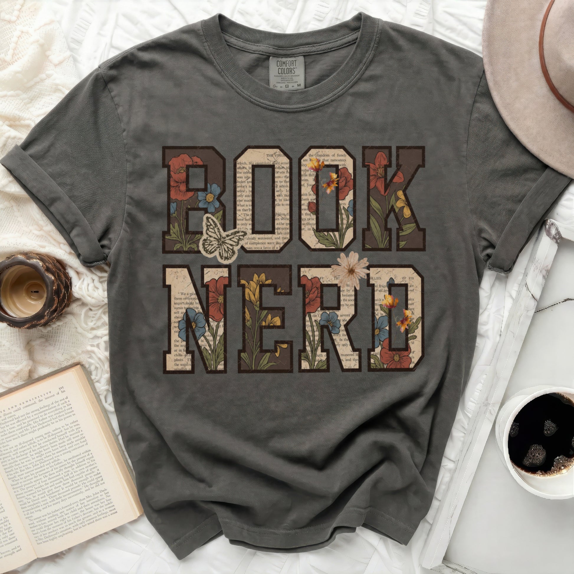 Comfort Colors t-shirt with "BOOK NERD" text and floral accents.