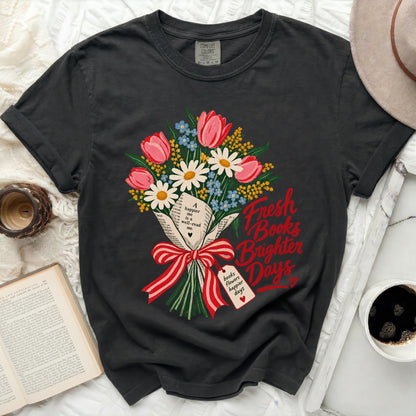 Dark t-shirt with floral bouquet and "Fresh Books Brighter Days" text.
