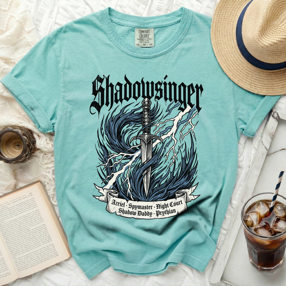 Teal t-shirt with "Shadowsinger" graphic and character names on a ribbon.