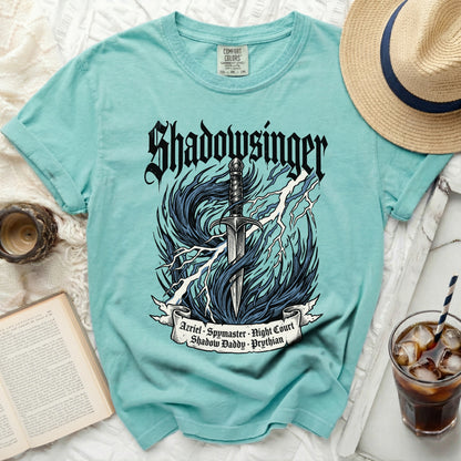 Teal t-shirt with "Shadowsinger" graphic and character names on a ribbon.