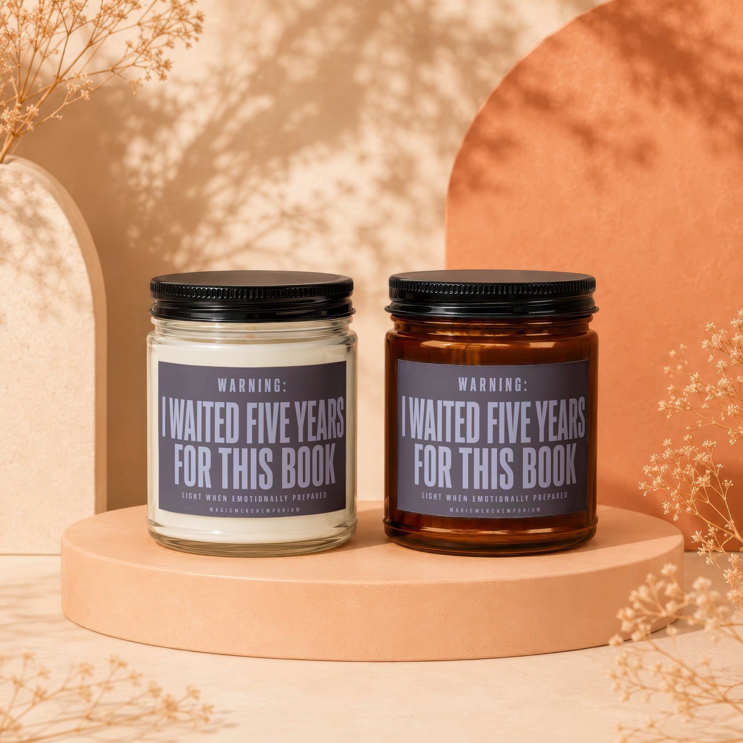 Two glass jars with black lids and labels reading "Warning: Waited Five Years For This Book."