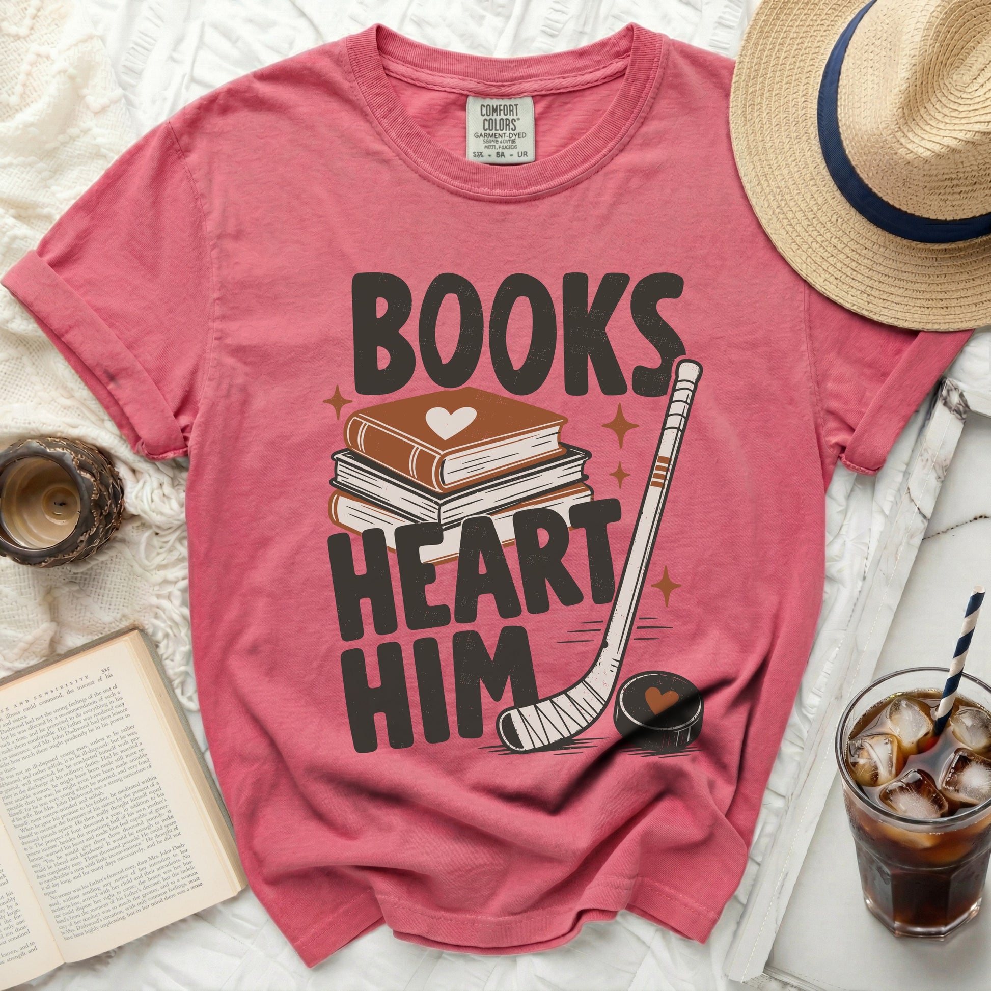 Pink t-shirt with "BOOKS HEART HIM" and book, hockey stick graphics.