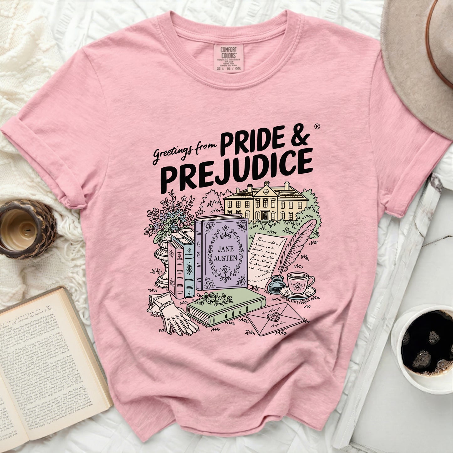 Pink t-shirt with "Greetings from PRIDE & PREJUDICE" and illustration.