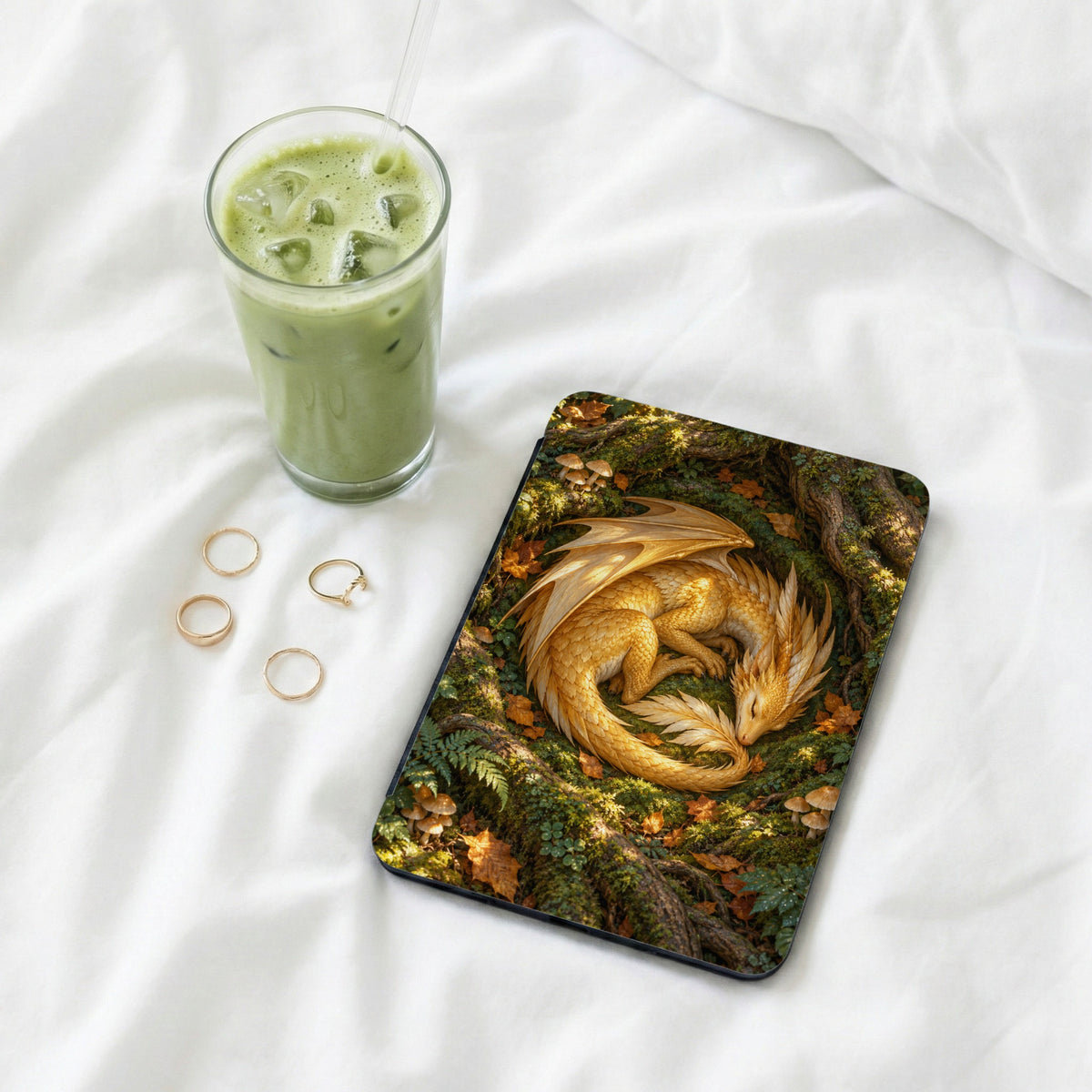 Tablet case with a sleeping golden dragon on a mossy forest floor.