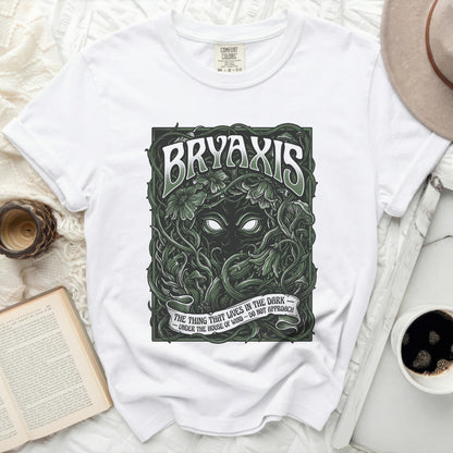 White t-shirt with "BRYAXIS" and creature art, "THE THING THAT LIVES IN THE DARK" text.