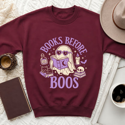 Maroon sweatshirt with graphic of ghost reading book, text "BOOKS BEFORE BOOS."