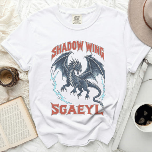 A white t-shirt featuring a blue dragon graphic with red text reading Shadow Wing and Sgaeyl.