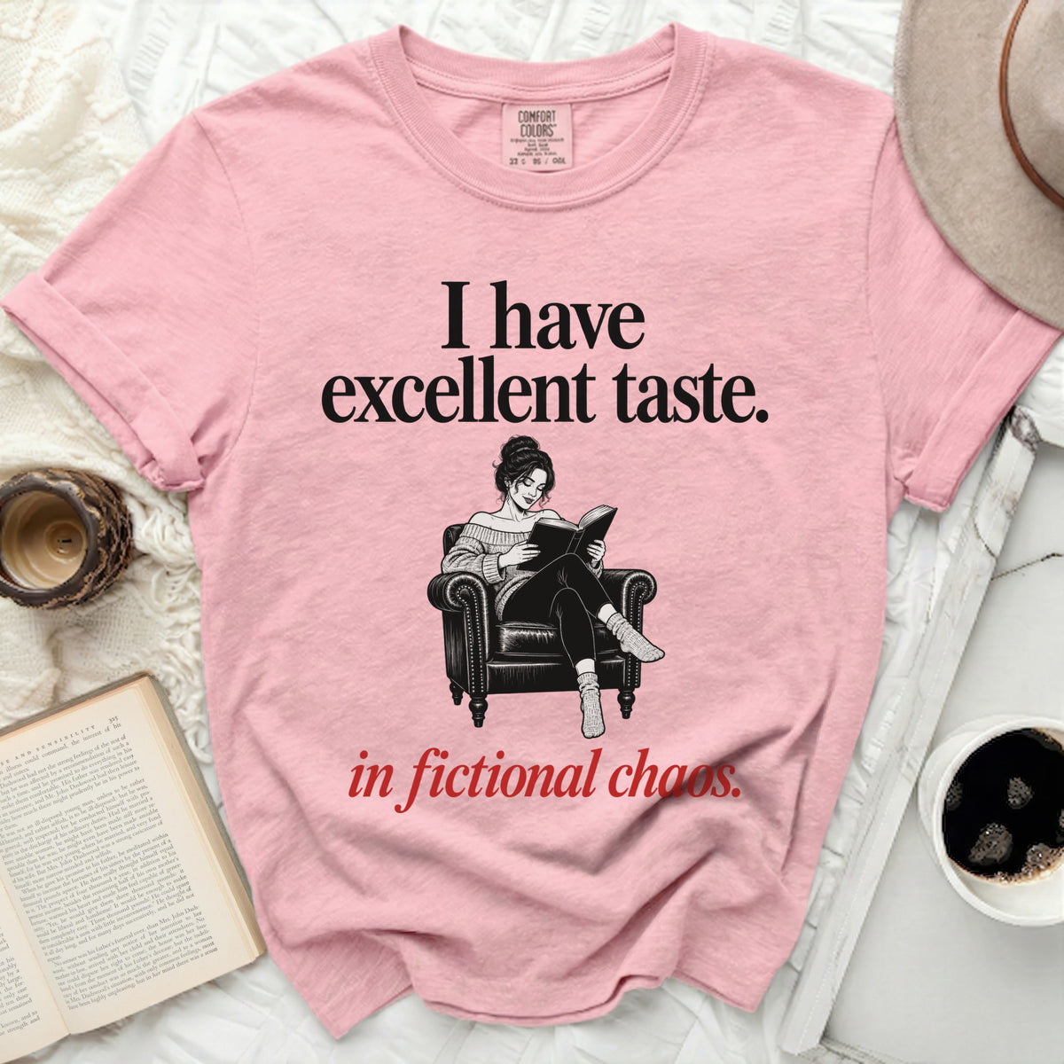Pink t-shirt with "I have excellent taste. in fictional chaos." and a book reader illustration.