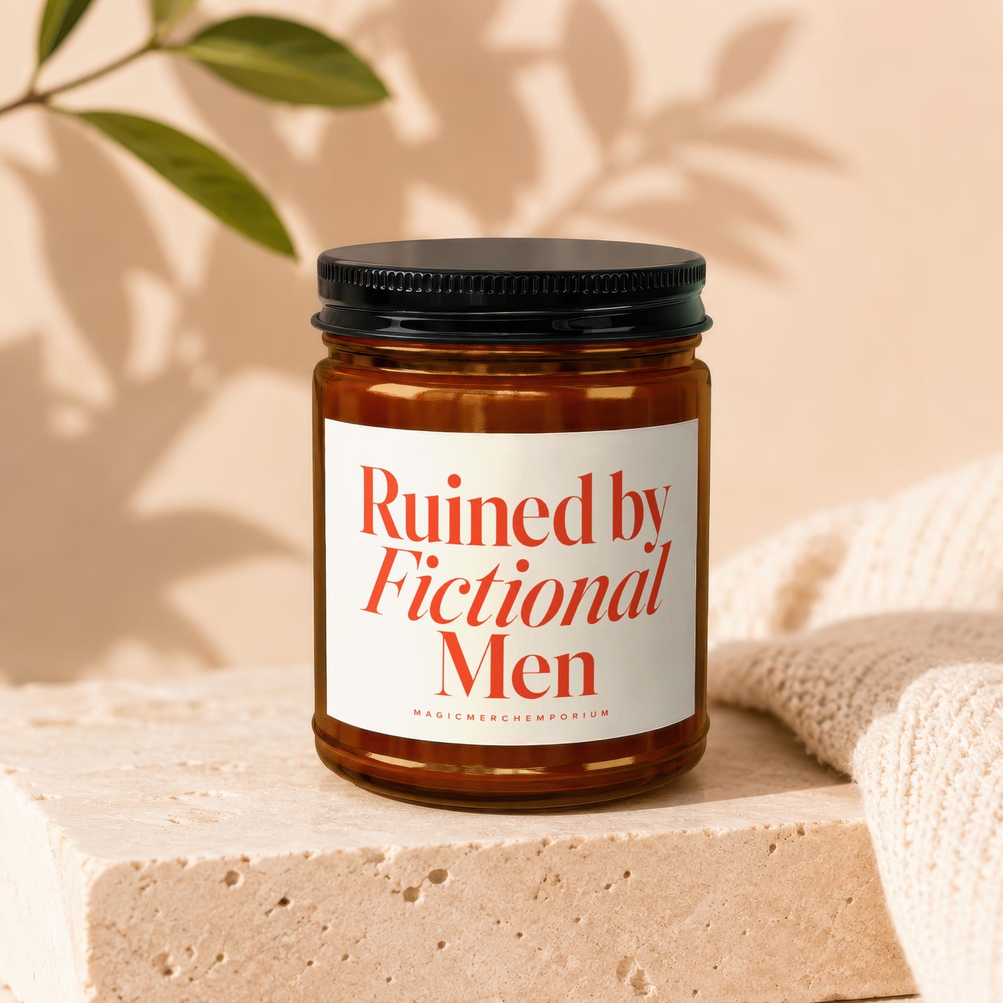 Amber glass candle with white label reading "Ruined by Fictional Men."