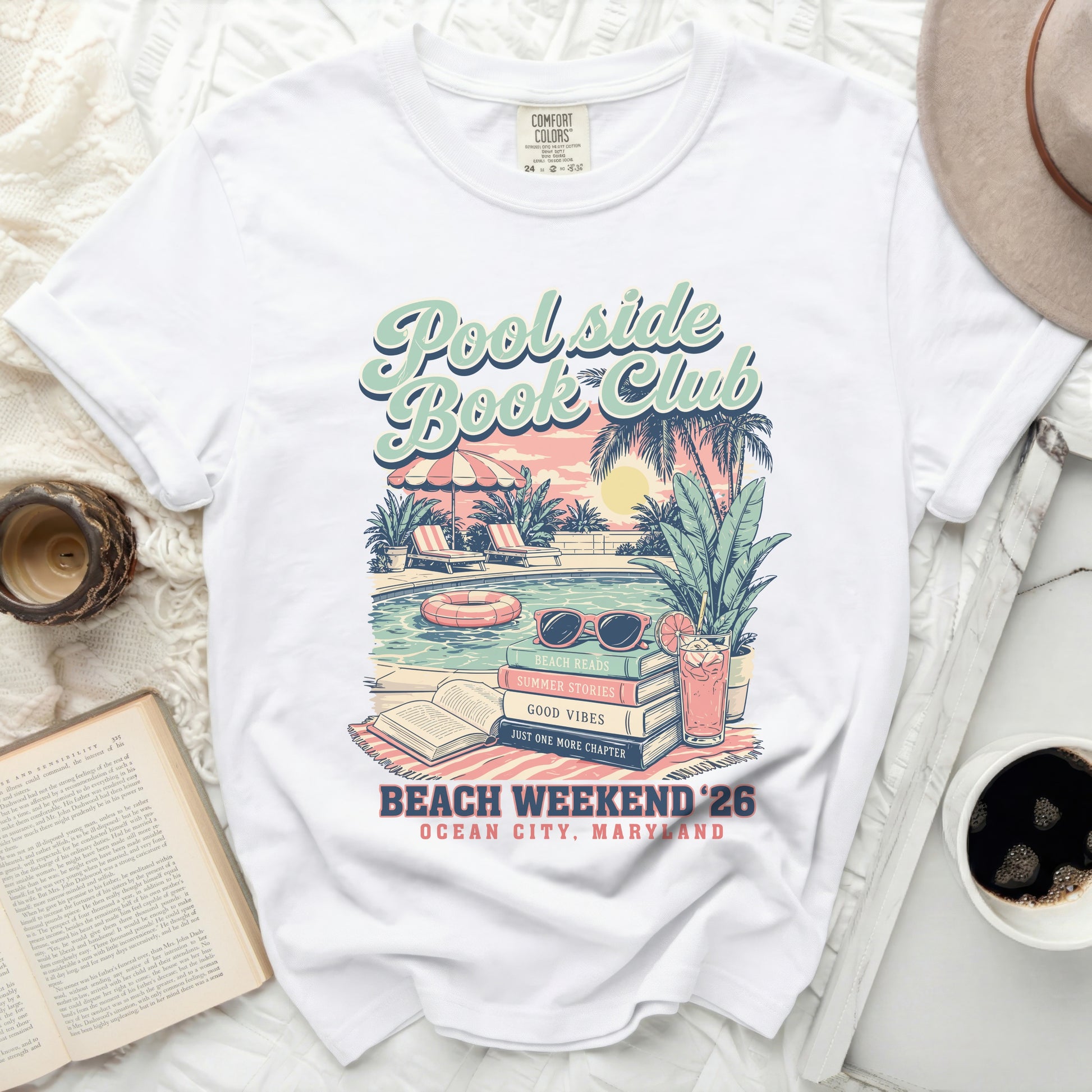White t-shirt with "Poolside Book Club" and beach scene graphic.