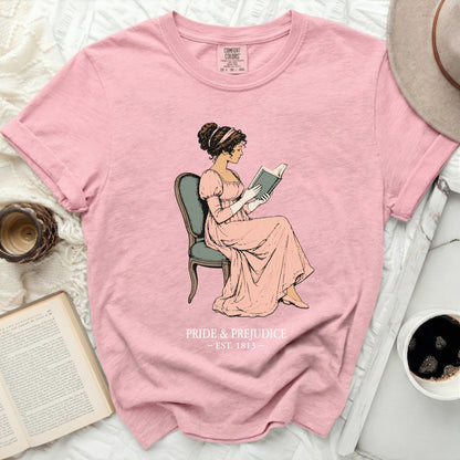 Pink t-shirt with "Pride & Prejudice Est. 1813" and a woman reading